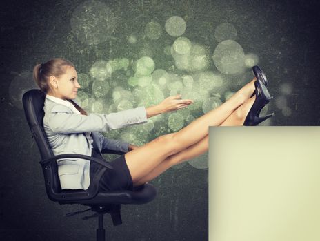 Businesswoman in office chair, looking at camera, with her feet up on anything, in front of scratched wall with sketch of city