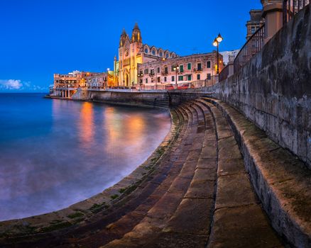 Balluta Bay and Church of Our Lady of Mount Carmel in Saint Julien, Malta