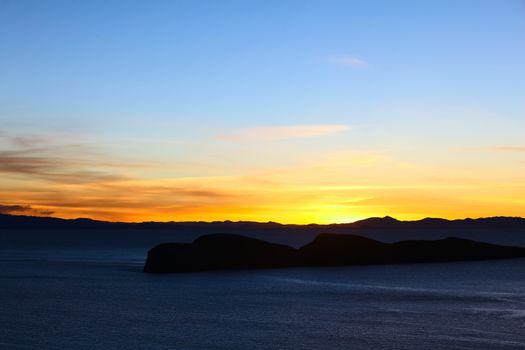 Sunset over Lake Titicaca and the island Jochihuata photographed from the northern end of the popular tourist destination of Isla del Sol (Island of the Sun) in Bolivia