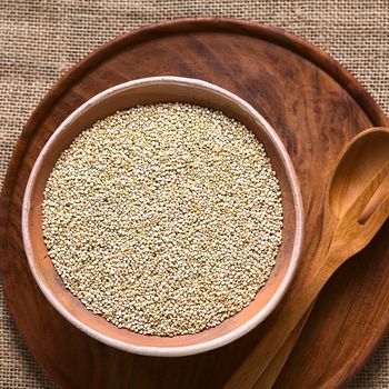 Raw white quinoa (lat. Chenopodium quinoa) grain seeds in bowl photographed with natural light 