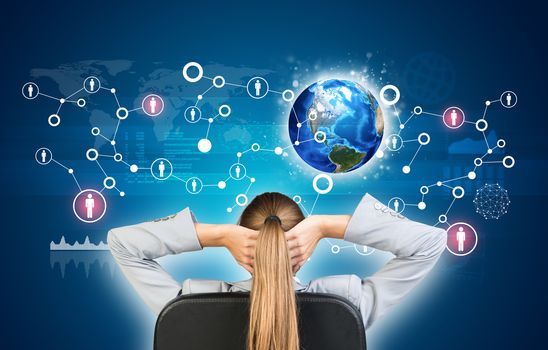 Businesswoman sitting on office chair with hands clasped behind her head, in front Earth, network with people icons and graphs. Element of this image furnished by NASA