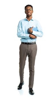 Happy african american college student standing with books in his hands on white background