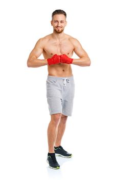 Athletic attractive man wearing boxing bandages on the white background