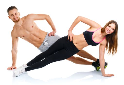 Sport attractive couple - man and woman doing fitness exercises on the white background