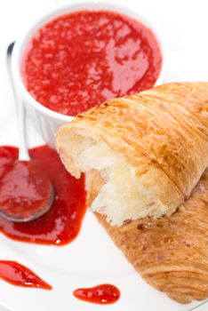 Close up strawberry jam croissant spoon cup