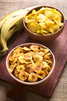 Bowls of sweet (front) and salty (back) plantain chips, a popular snack in South America photographed with natural light (Selective Focus, Focus in the middle of the first bowl) 