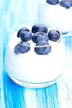 Tasty fresh blueberry yoghurt shake dessert on table