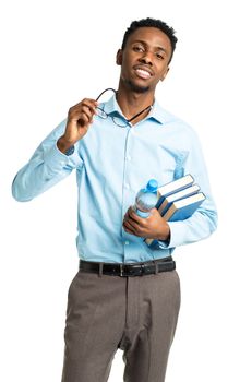 Happy african american college student standing with books in his hands on white background