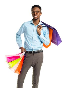 Happy african american man holding shopping bags on white background. Holidays concept