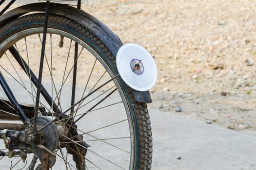 cd disc on rear mudguard of bicycle, used as reflector, thailand