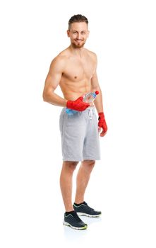 Sport attractive man wearing boxing bandages with bottle of water on the white background