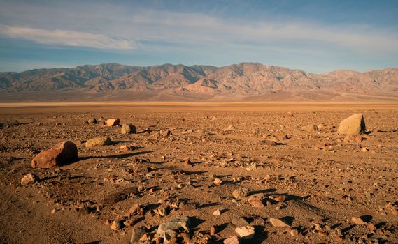 The sun rises to light the dry basin in Death Valley