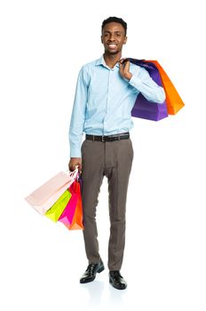 Happy african american man holding shopping bags on white background. Holidays concept