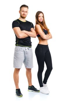 Sport couple - man and woman after fitness exercise on the white background