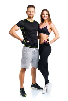 Sport couple - man and woman after fitness exercise on the white background