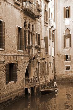 Italy. Venice. Romantic canal with boat. In Sepia toned. Retro style