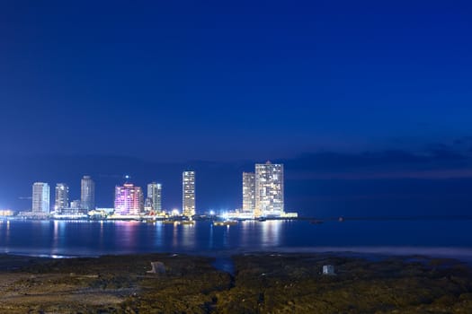IQUIQUE, CHILE - JANUARY 22, 2015: The peninsula at the end of Cavancha beach with hotels  and modern apartment buildings photographed in the evening on January 22, 2015 in Iquique, Chile 