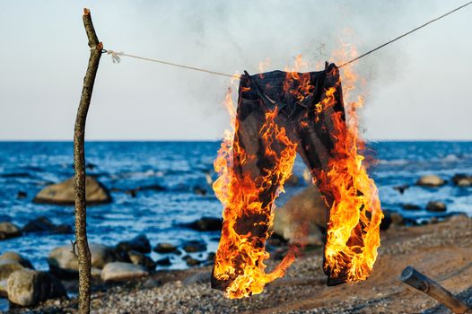 Pants burning on a rope on a seashore