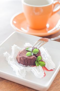 Chocolate lava cake with fork and coffee cup, stock photo