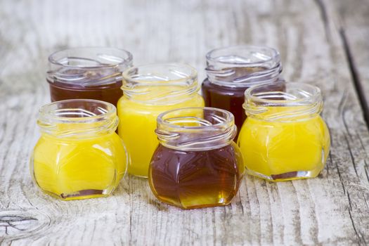 jars of honey on wooden background