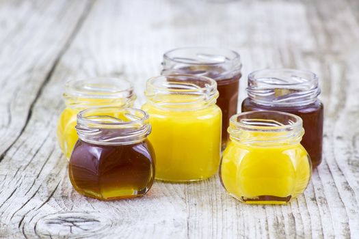 jars of honey on wooden background