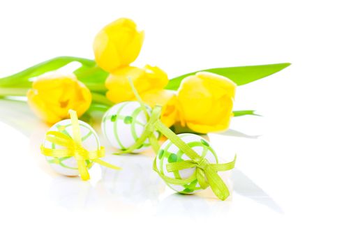 easter eggs with yellow tulip flowers isolated on white background