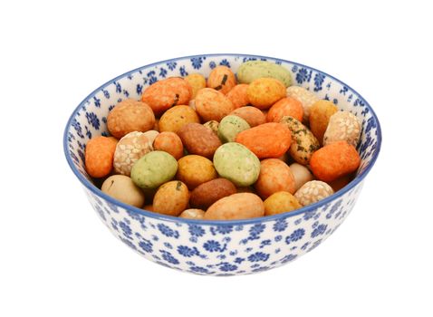 Seaweed peanuts in a blue and white porcelain bowl with a floral design, isolated on a white background