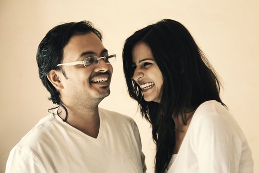 Happy moment of Indian couple felling love and smiling to watch each other