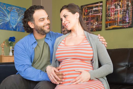Bearded husband touching happy smiling pregnant wife