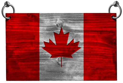 Wooden Canadian flag hanging on to two steel ring isolated on white background with clipping path
