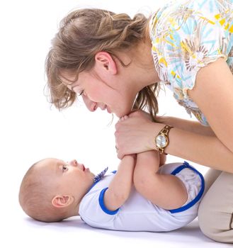 studio shot of baby boy lying on white floor