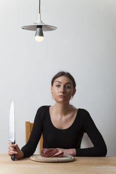 woman with meat and a knife