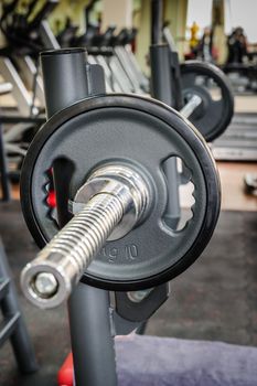 Barbell ready to workout, indooors, shallow DOF