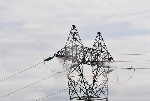 Electrical Pylon Cleaning by Two Guys with a Cloudy Sky