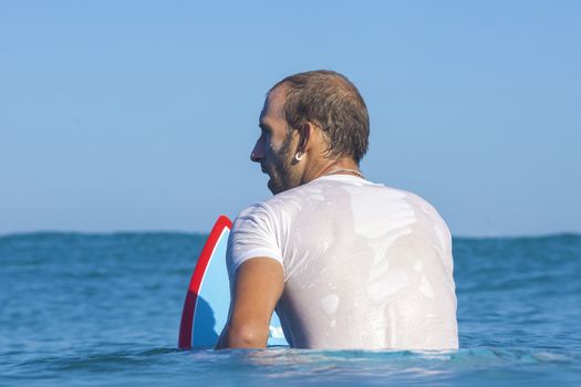 Surfer on Amazing Blue Wave, Bali island.