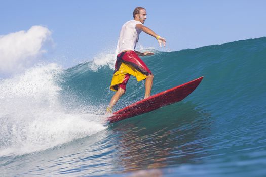 Surfer on Amazing Blue Wave, Bali island.