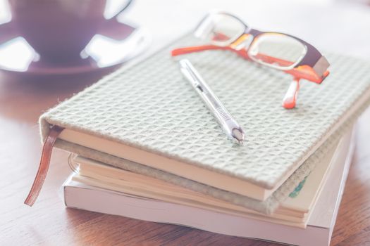 Workplace in coffee shop with pen and notebooks, stock photo