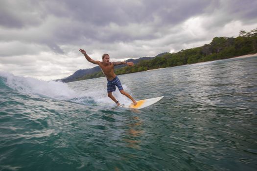 Surfer on Amazing Blue Wave, Bali island.