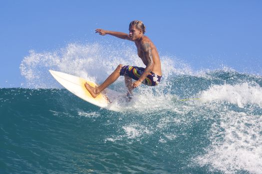 Surfer on Amazing Blue Wave, Bali island.