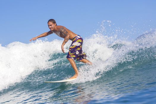 Surfer on Amazing Blue Wave, Bali island.