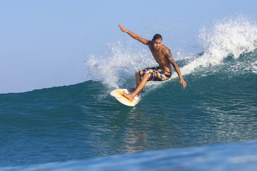 Surfer on Amazing Blue Wave, Bali island.