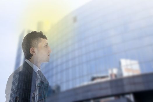 Double exposure of business man with office building