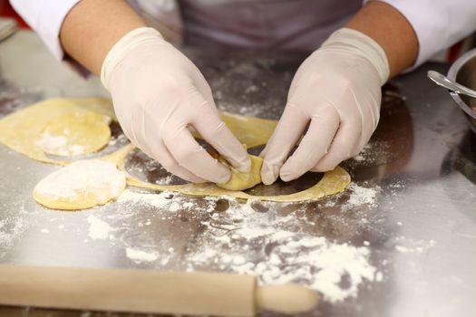 A chef is preparing handmade fresh pasta fettuccine and ravioli