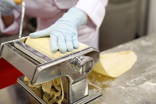 A chef is preparing handmade fresh pasta fettuccine and ravioli