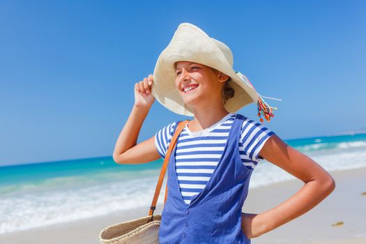 Summer vacation, lovely girl walking on the beach near water