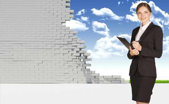 Businesswoman smiling and looking at camera. Dilapidated brick wall, green meadow and sky as backdrop. Business concept