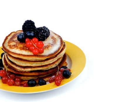 Yellow Plate with Stack of Delicious Pancakes with Red Currant, Blackberry, Blueberry and Sugar Powder isolated on white background