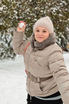 girl holding a snowball