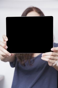 blank black screen tablet close on blue shirt woman hands