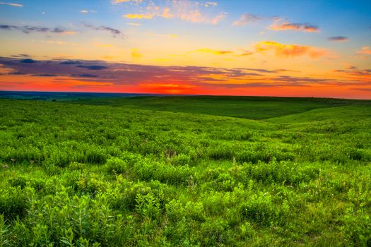 Sunset over the prairie land that is so important to the ranchers in the Flint Hills of Kansas.  Kansas is also known to be one of the top 10 places in the world for sunsets.